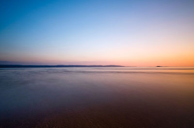 Scenic view of sea at sunset