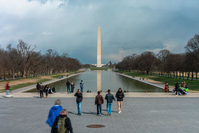 Group of people in front of built structure against sky