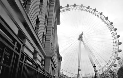 Low angle view of ferris wheel in city