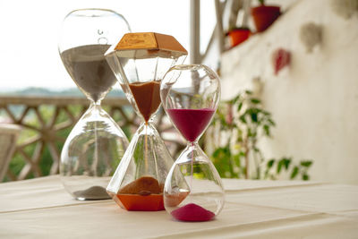 Three hourglasses dropping their content thanks to gravity