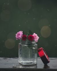 Close-up of flowers in jar on table