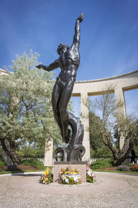 Low angle view of statue against sky