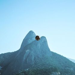 Low angle view of mountain against clear blue sky