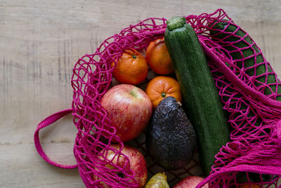 Eco friendly and reusable shopping mesh bag with fruits and vegetables