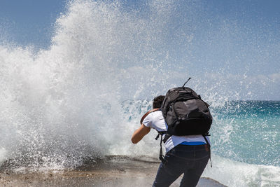 Man photographing wave