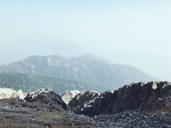 Scenic view of sea and mountains against sky