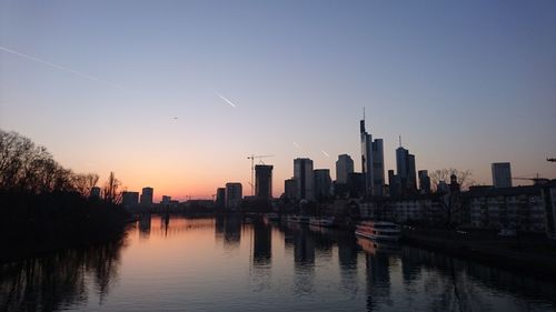 View of city at waterfront during sunset