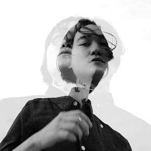 Double exposure image of young man against clear sky