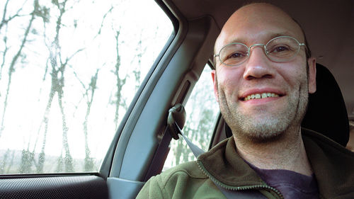 Portrait of smiling man sitting in car