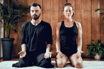 Man doing yoga with woman