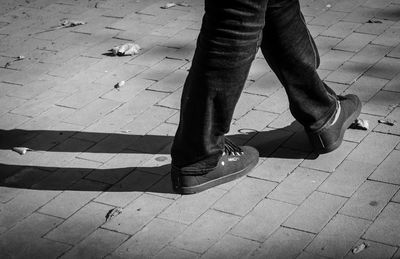 Low section of woman standing on tiled floor