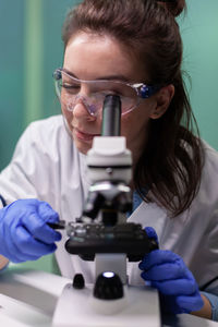 Scientist using microscope at lab