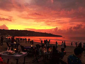 Group of people at beach during sunset