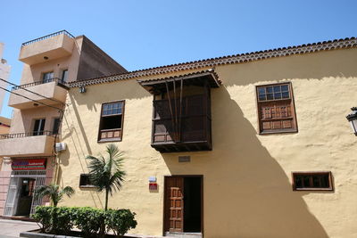 Low angle view of buildings against clear sky