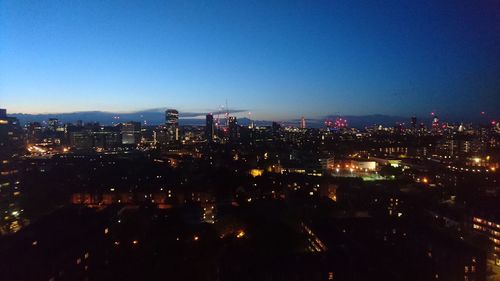 Aerial view of city lit up at night