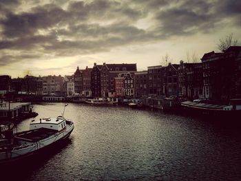 Boats in river with buildings in background