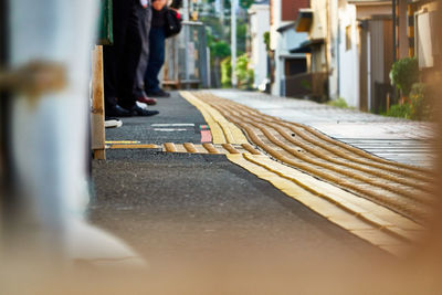 Low section of man standing on railroad station