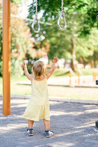 Rear view of girl playing at playground