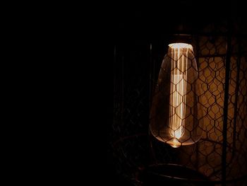 Close-up of illuminated lamp in darkroom