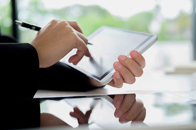 Midsection of person holding mobile phone