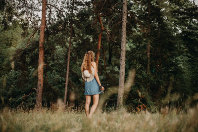 Woman standing in forest