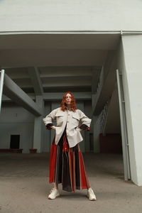 Rear view of woman standing against wall