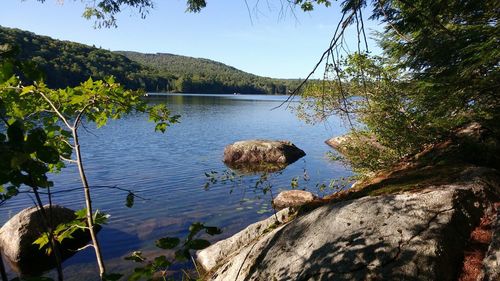 Scenic view of lake and mountains against sky