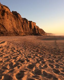 Scenic view of beach against clear sky