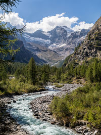 Scenic view of mountains and river against sky