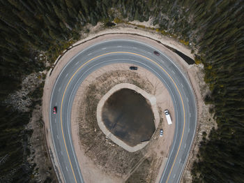 Aerial view of vehicles on road amidst trees