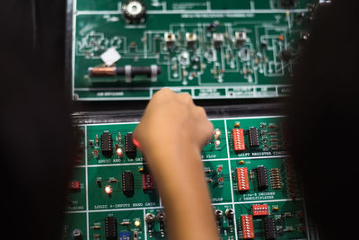 Cropped hand repairing circuit board