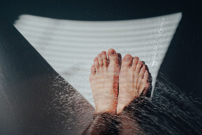 High angle view of water splashing over legs