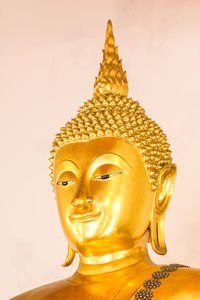 Close-up of buddha statue against building