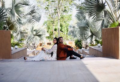 Woman sitting on palm tree