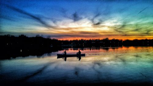 Boat in lake at sunset