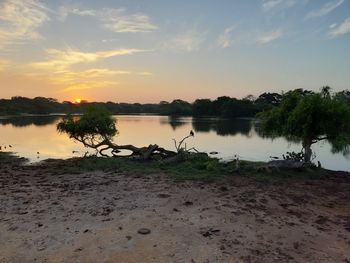 Scenic view of lake against sky during sunset