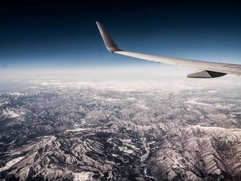 Aerial view of aircraft wing against sky