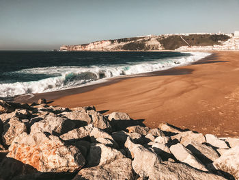 Scenic view of beach against clear sky