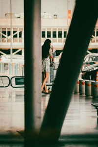 Side view of woman standing by railing