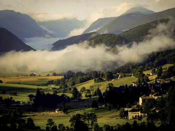 Scenic view of landscape and mountains during foggy weather