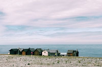 Lifeguard hut on beach against sky