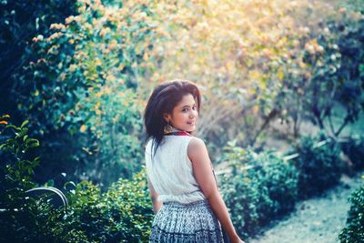 Portrait of smiling young woman standing outdoors