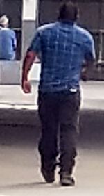 Rear view of man walking on street