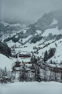 Snow covered land and mountains against sky