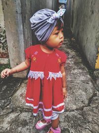 Cute girl looking away while standing outdoors