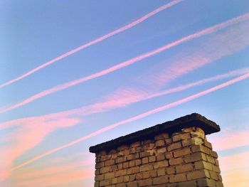 Low angle view of built structure at sunset