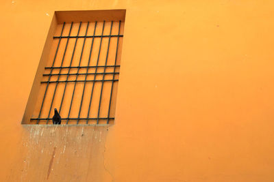 View of yellow wall against orange sky