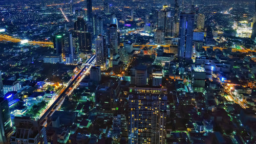 High angle view of illuminated buildings in city at night