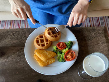 High angle view of man preparing food on table