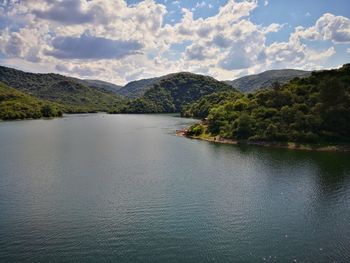 Scenic view of lake and mountains against sky